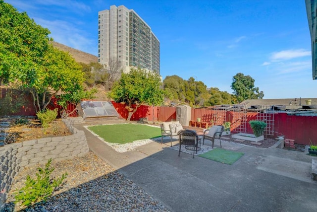 view of patio featuring a storage unit