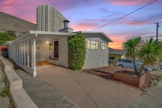 back house at dusk with a carport