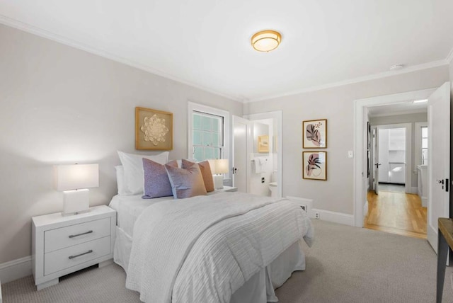 bedroom featuring light carpet, ensuite bathroom, and crown molding