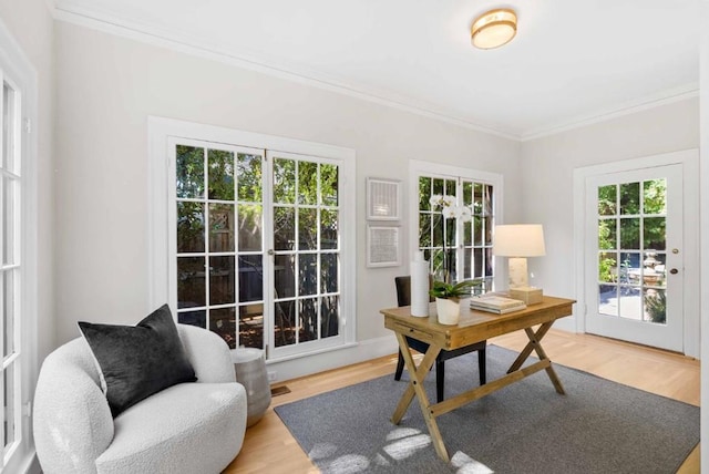 office space featuring hardwood / wood-style flooring, a wealth of natural light, and ornamental molding