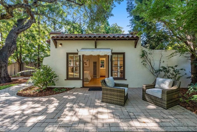 rear view of property featuring a patio