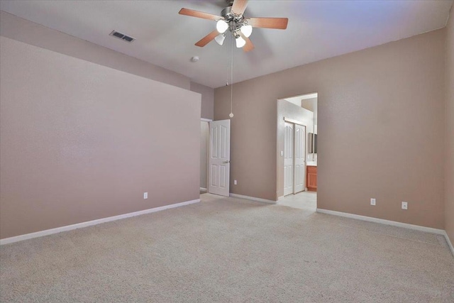 unfurnished room featuring light colored carpet and ceiling fan