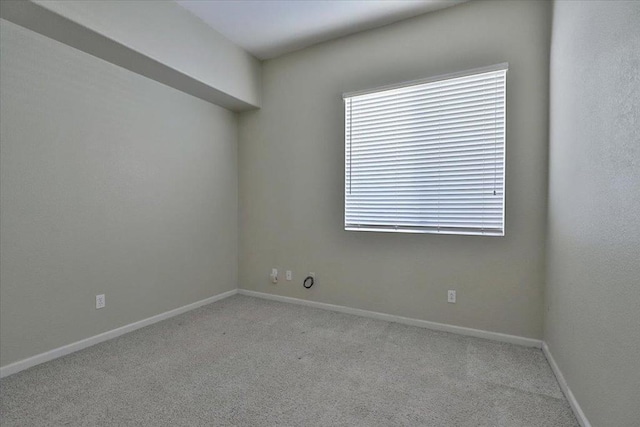 spare room featuring light colored carpet