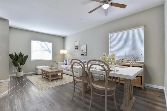 dining space with dark wood-type flooring and ceiling fan