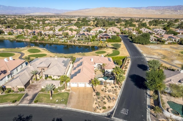 drone / aerial view featuring a water and mountain view