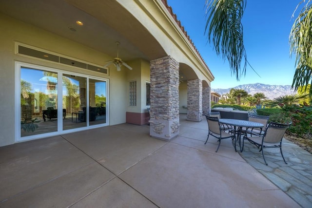 view of patio featuring a mountain view and ceiling fan