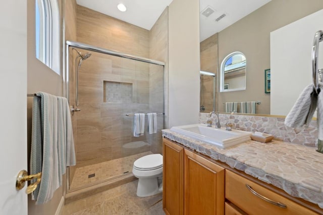 bathroom with vanity, toilet, and an enclosed shower