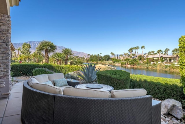 view of patio featuring a water and mountain view