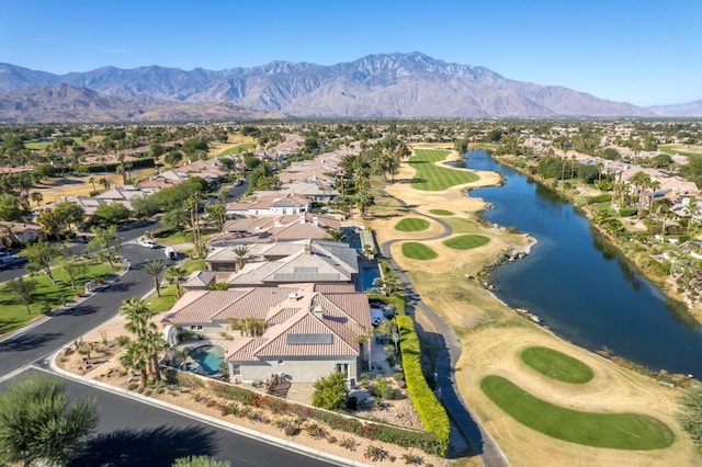 birds eye view of property with a water and mountain view