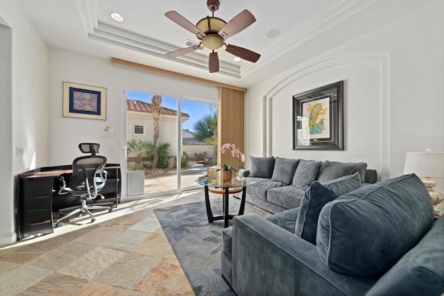 living room with crown molding, ceiling fan, and a tray ceiling