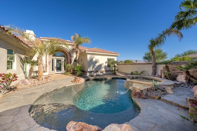 view of pool featuring an in ground hot tub, a patio area, and pool water feature