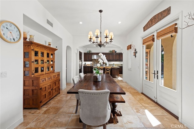 dining space with an inviting chandelier and french doors