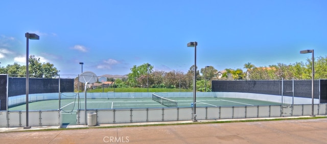 view of tennis court featuring basketball court