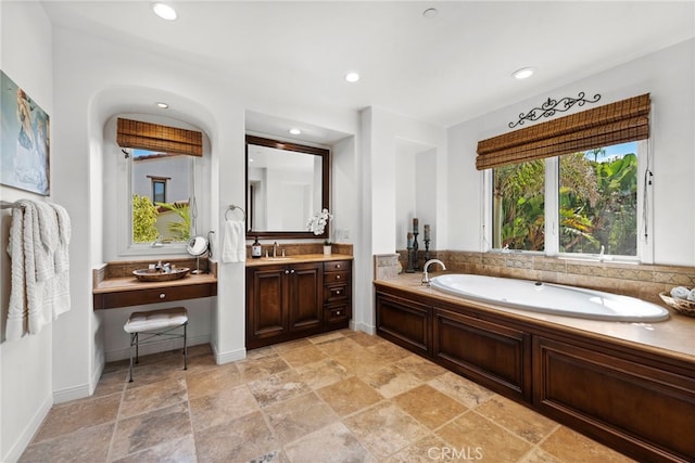 bathroom featuring vanity and a tub