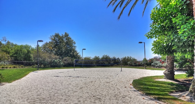 surrounding community with volleyball court and a yard