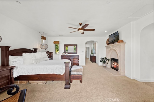 bedroom featuring light colored carpet and ceiling fan