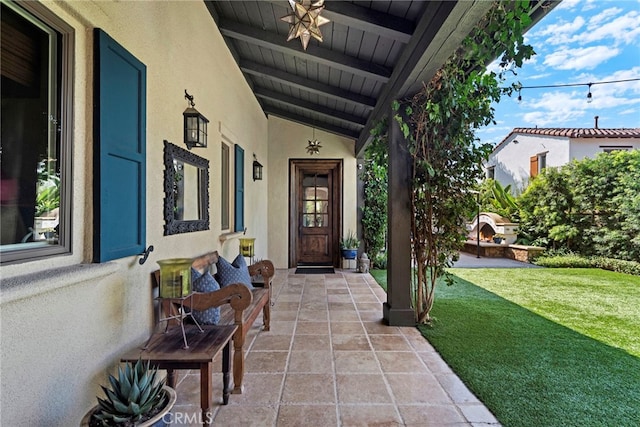 doorway to property featuring a yard