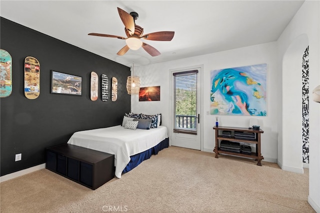 carpeted bedroom featuring ceiling fan and access to exterior