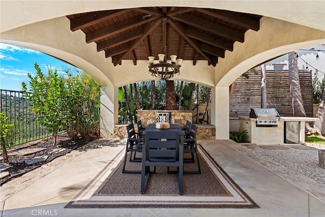 view of patio / terrace featuring exterior kitchen and a grill