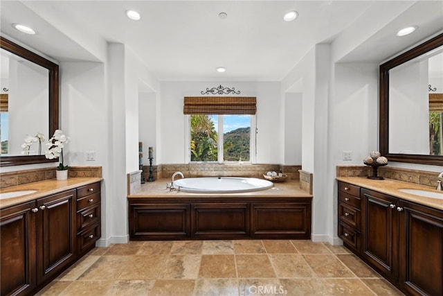 bathroom featuring a tub to relax in and vanity