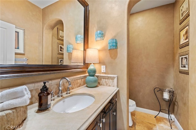 bathroom featuring toilet and vanity