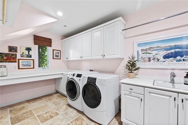 washroom with sink, cabinets, and washing machine and clothes dryer