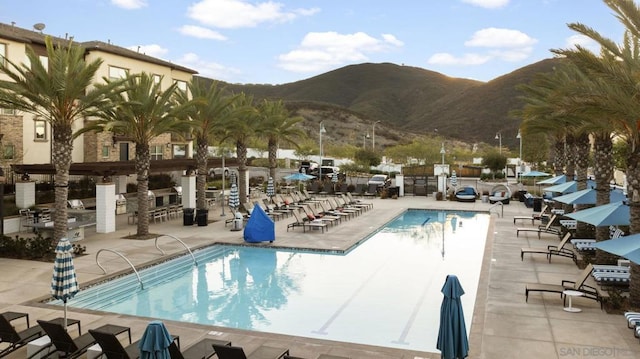 view of swimming pool featuring a mountain view and a patio area