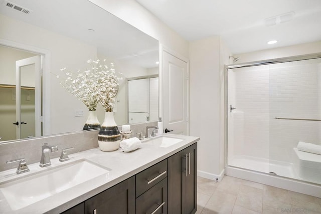 bathroom with walk in shower, tile patterned floors, and vanity