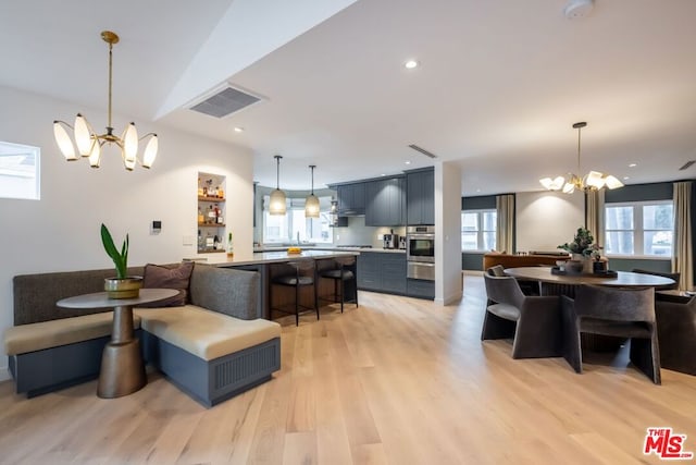 dining area with an inviting chandelier and light wood-type flooring