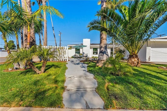 exterior space featuring fence and a lawn