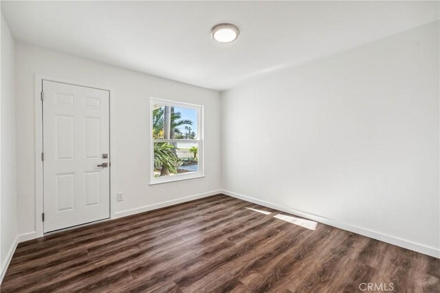 unfurnished room featuring dark hardwood / wood-style floors