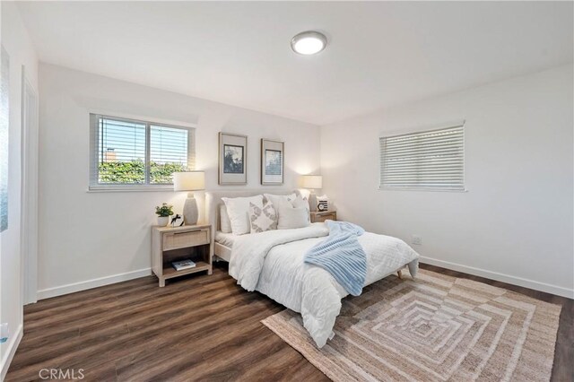 bedroom with dark wood-type flooring