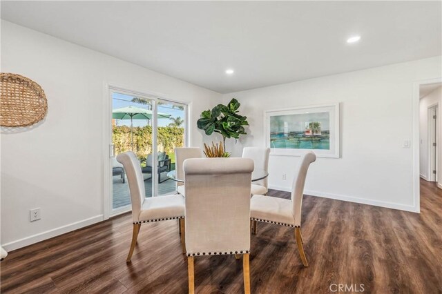 dining room with dark hardwood / wood-style flooring