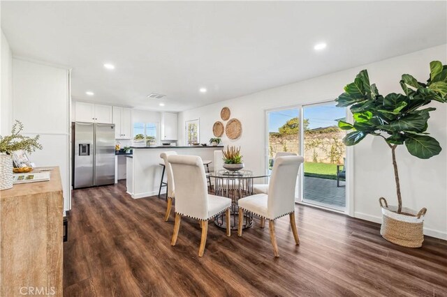 dining space with dark hardwood / wood-style flooring