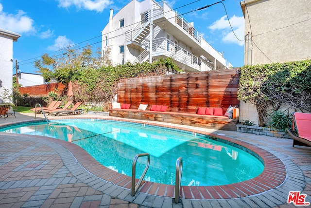 view of swimming pool with a patio area