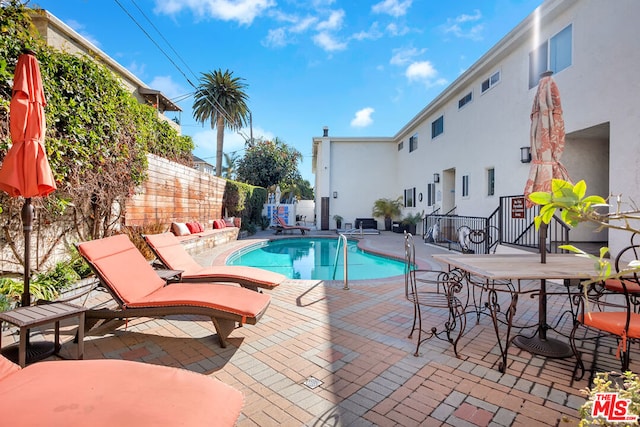 view of swimming pool with a patio area