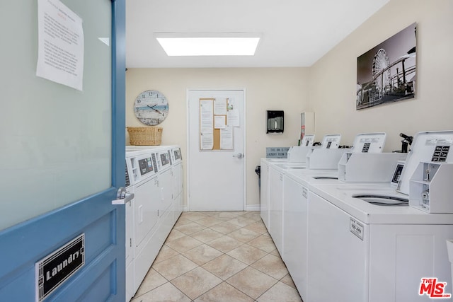 washroom featuring independent washer and dryer and light tile patterned floors