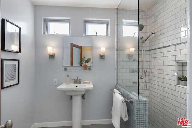 bathroom featuring a shower with door