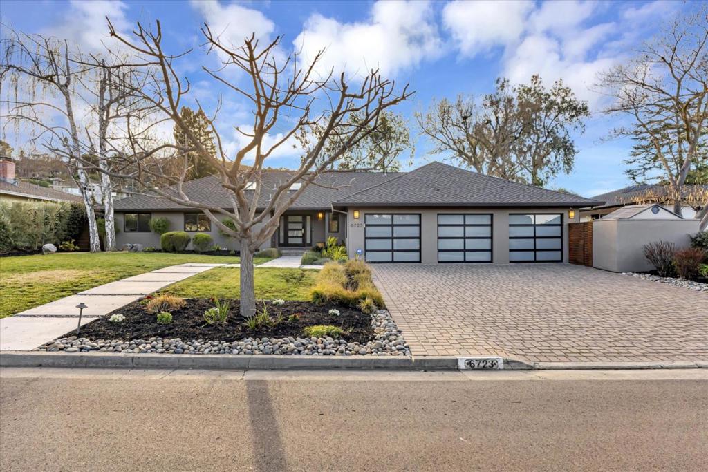 view of front of home with a garage and a front lawn