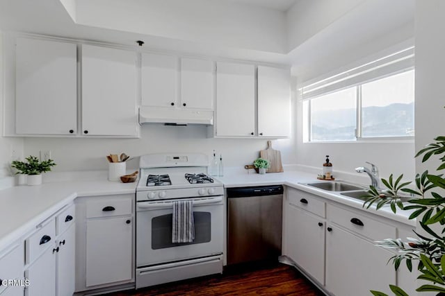 kitchen with white gas range oven, white cabinets, stainless steel dishwasher, and sink