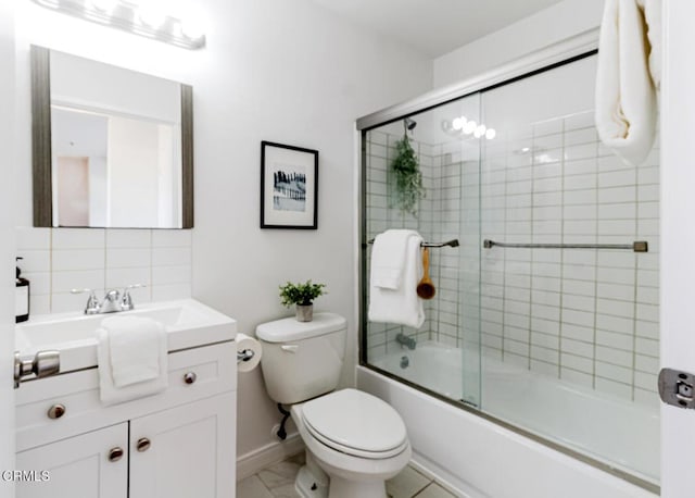 full bathroom with combined bath / shower with glass door, backsplash, toilet, and vanity