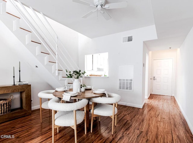 dining area with ceiling fan and dark wood-type flooring