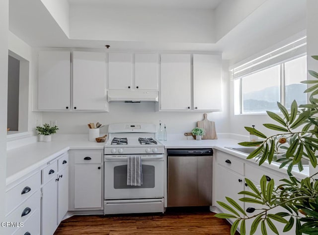 kitchen featuring white cabinets, dishwasher, white gas stove, and dark hardwood / wood-style flooring