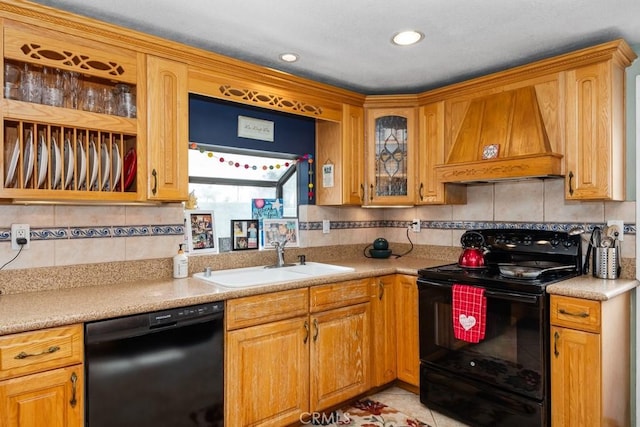 kitchen featuring premium range hood, sink, black appliances, light tile patterned floors, and backsplash