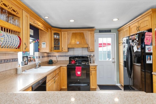 kitchen with sink, backsplash, custom exhaust hood, and black appliances