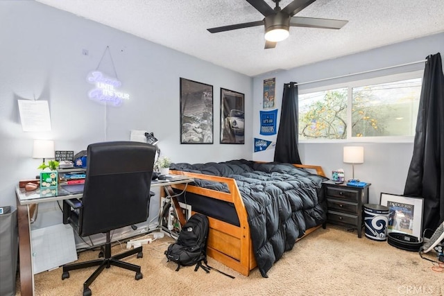 carpeted bedroom featuring a textured ceiling and ceiling fan