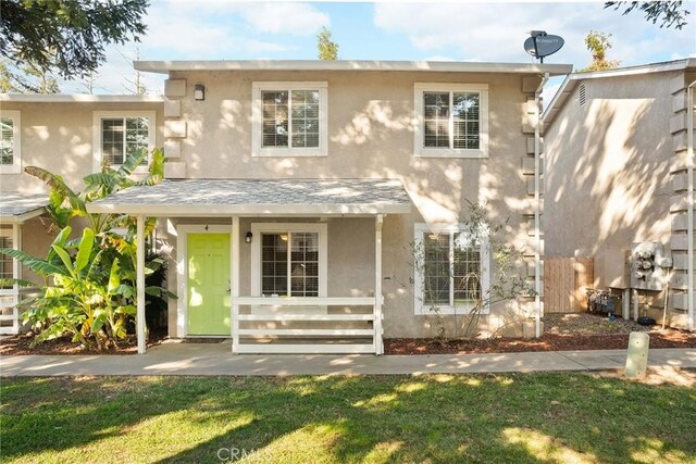 rear view of property with a yard