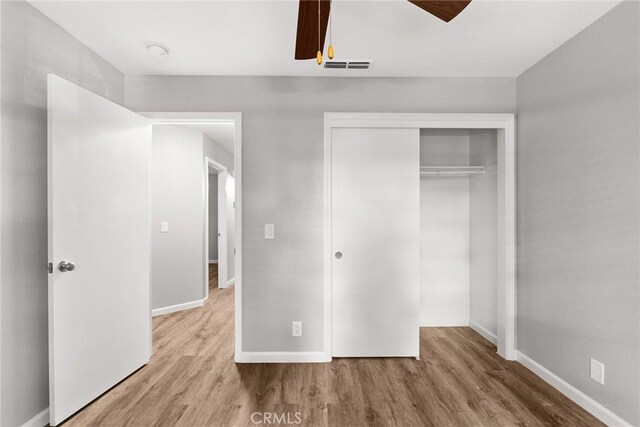 unfurnished bedroom with a closet and light hardwood / wood-style flooring