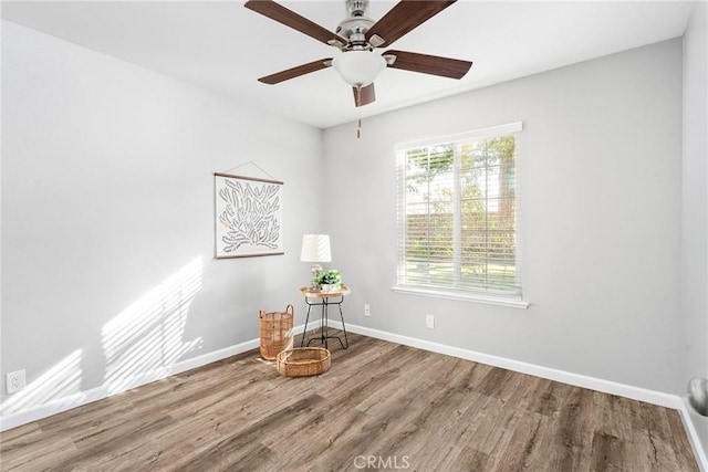 interior space with ceiling fan and wood-type flooring