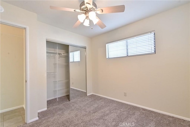 unfurnished bedroom with light carpet, a closet, and ceiling fan